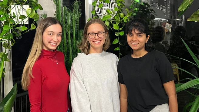 Three Green Office Munich members smiling with plants in background